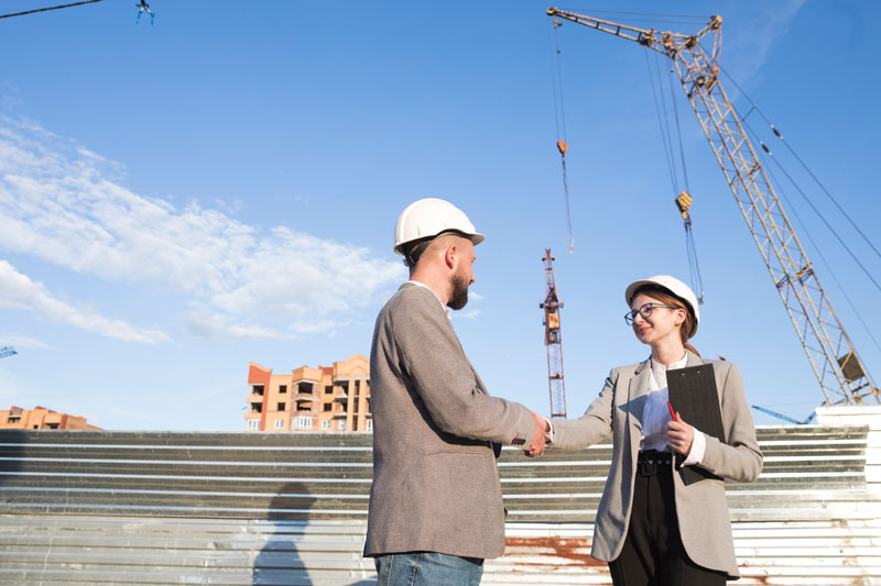 Two-professional-engineer-shaking-hand-construction-site.jpg